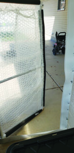 View of the door from the inside, showing the floorboard material and foam pipe insulation…
